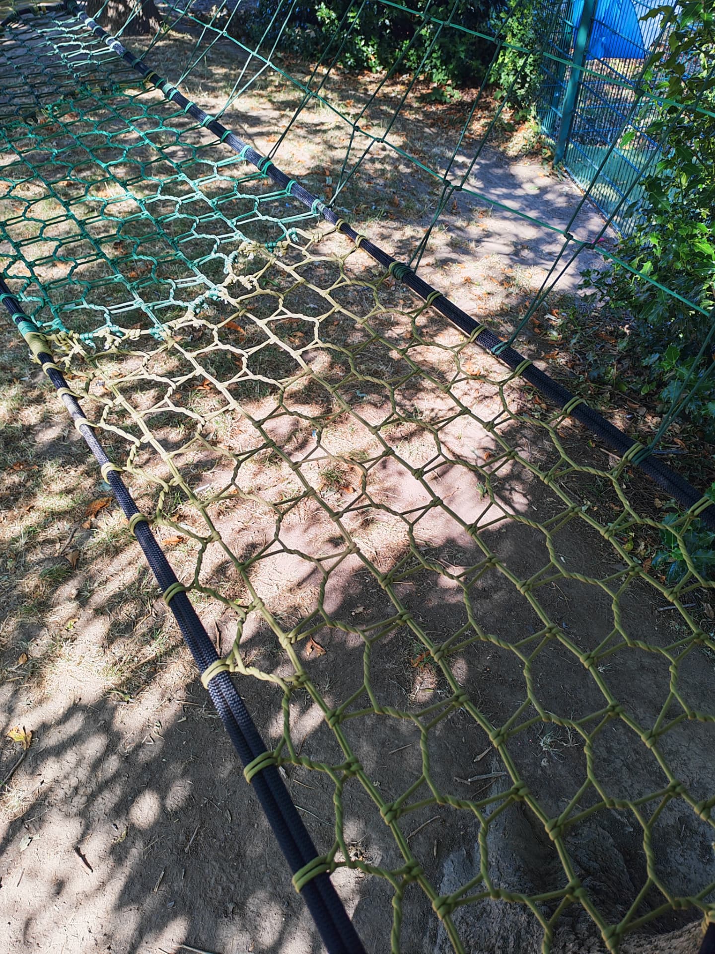 Close view of the hand-knotted green and olive netting of the Westdale Primary School net