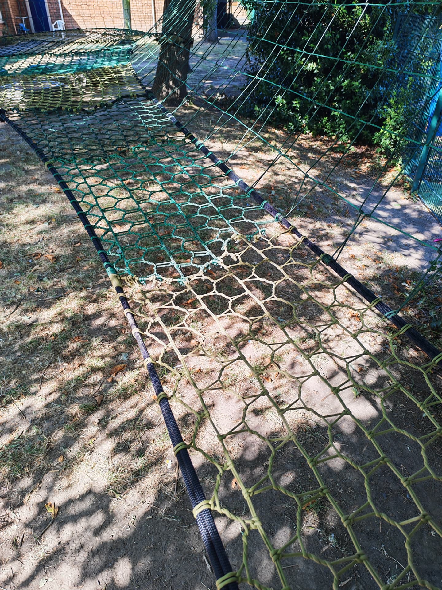 Long span of the Westdale Primary School climbing net beside the playground fence