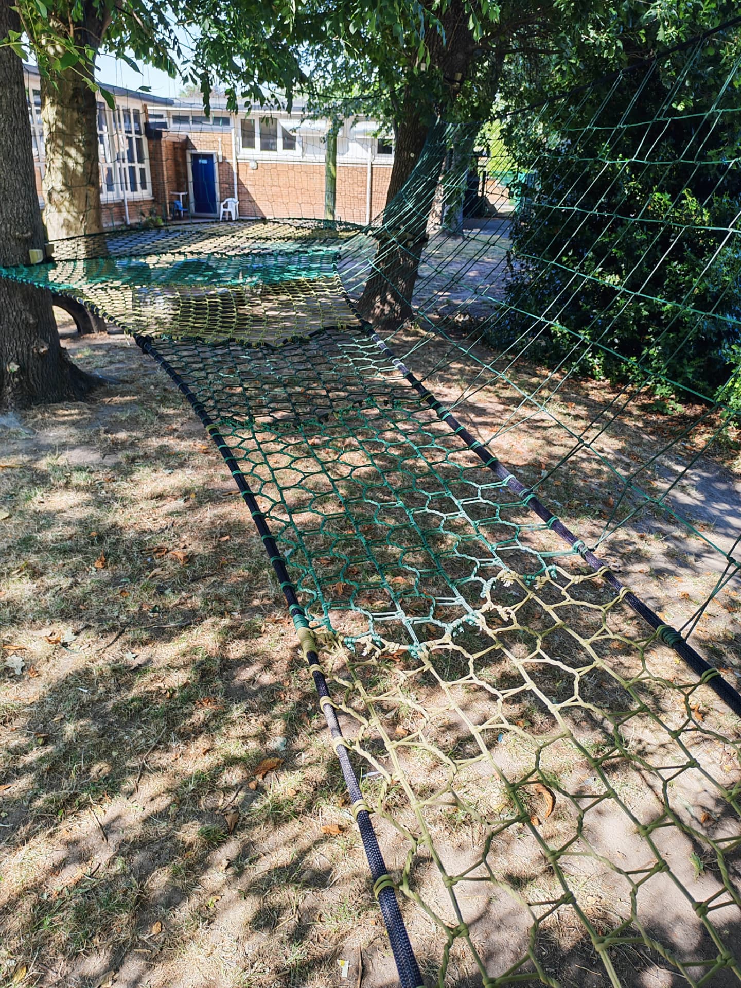 Wide view of the two-level Westdale Primary School TreeNet strung between trees in the school grounds